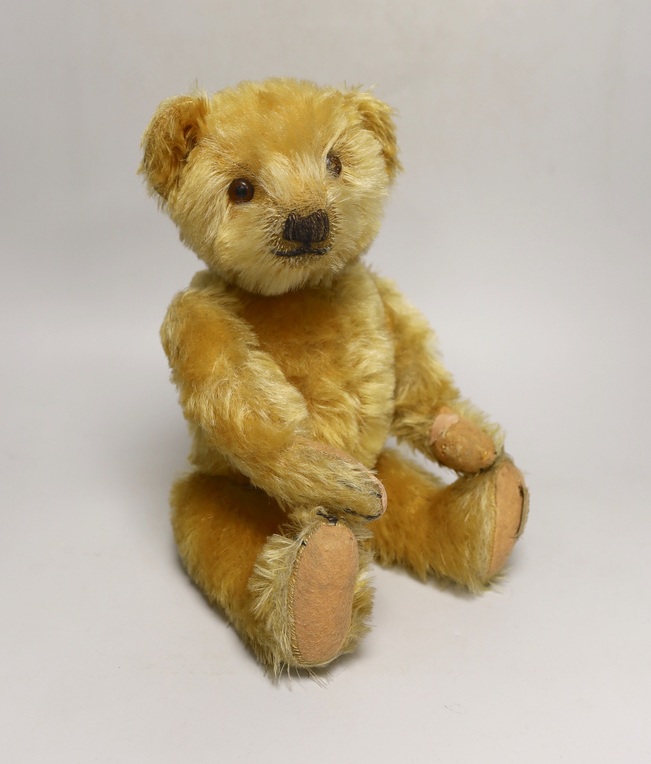 A Deans 1950's mouse eared bear, label on left foot, 16in., repair to paw pads, good mohair